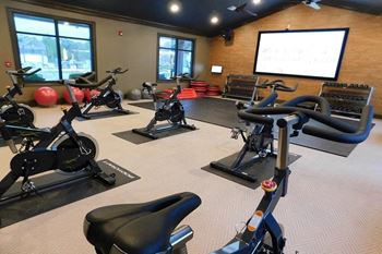 a room filled with lots of different types of exercise equipment  at Reserve at Gulf Hills Apartment Homes, Ocean Springs 